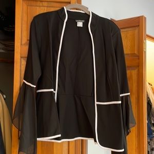 Black blazer with white trim and sheer bell sleeves at the end